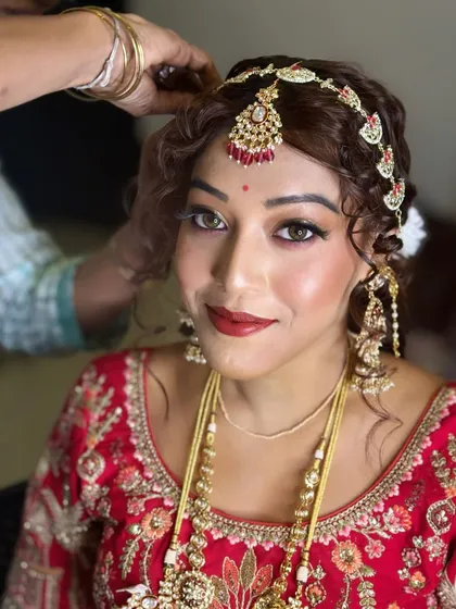 Here, I am applying the finishing touches with a compact powder to ensure the makeup is flawless and long-lasting. This is a key step in my process.