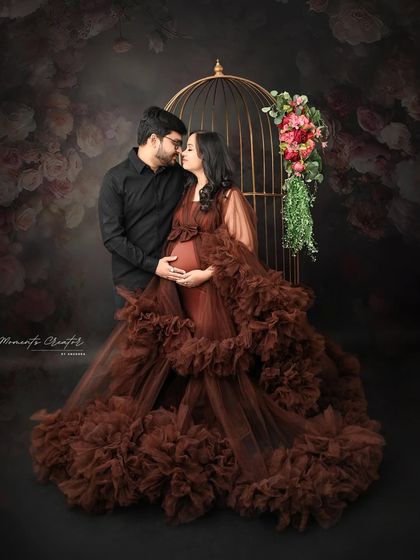 An intimate moment captured. The couple's close embrace and loving gaze make this a deeply romantic and emotional maternity photograph.