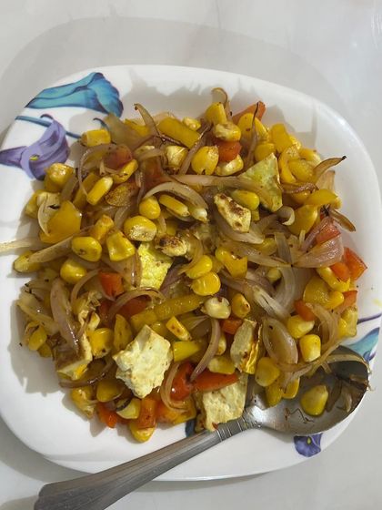 A colorful bowl of corn and paneer salad. A simple, no-cook meal that is perfect for a quick lunch or snack.