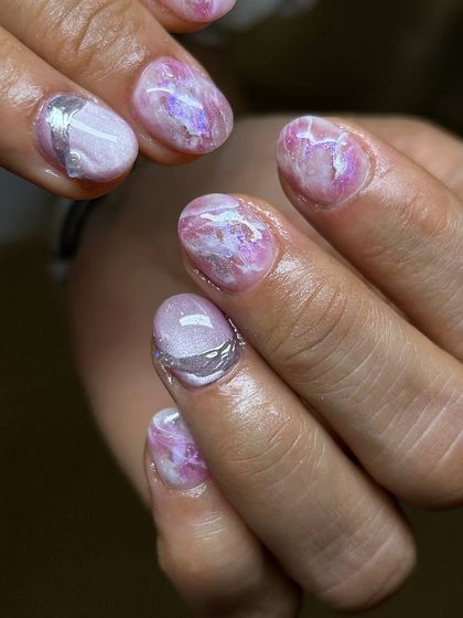 A delicate and artistic design featuring a marbled pink base with subtle silver accents. The texture and soft colors create a look reminiscent of rose quartz.