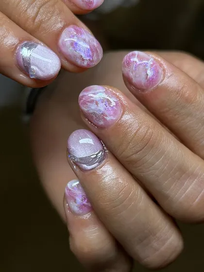 A delicate and artistic design featuring a marbled pink base with subtle silver accents. The texture and soft colors create a look reminiscent of rose quartz.