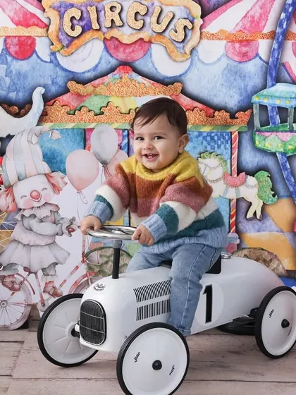 Welcome to the carnival! This vibrant and playful theme is perfect for celebrating a milestone. With a colorful circus backdrop and fun props like a retro toy car, we create a world of fun and excitement.