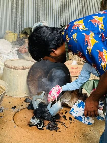 A student gets a close look at the results of a pit firing, another exciting and unpredictable firing technique we explore.