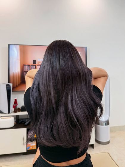 Here is the result of a color correction that was perfected with a glossing treatment. The final look is a deep, cool-toned color with a smooth, mirror-like shine that reflects the restored health of the hair.