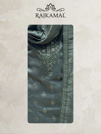 A detailed look at the fabric of the hunter green jacquard kurta, showing the subtle self-design and the embroidered neckline.