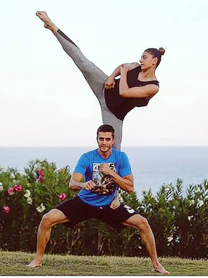 A demonstration of partner-assisted training, showing a powerful high kick. We often use partner drills to improve technique, trust, and coordination.