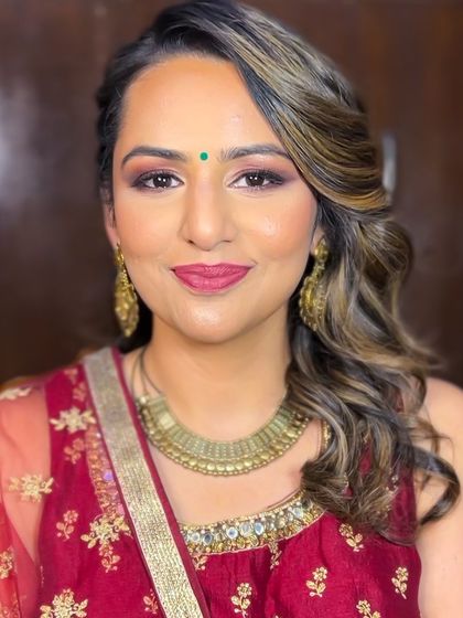 Our beautiful client Malhar ready for her friend's wedding. We created a warm, bronzy smokey eye with a deep pink lip to complement her maroon outfit.