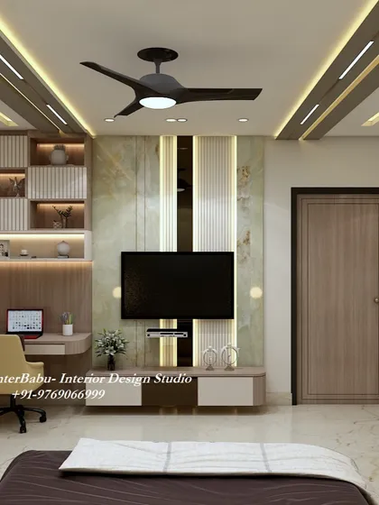 This view shows the integrated TV unit and study desk, which are designed with a mix of marble and wood finishes for a luxurious and warm feel.