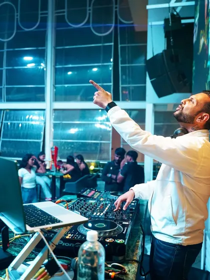 On the mic, interacting with the crowd. I'm not just a DJ; I'm the host of the party.