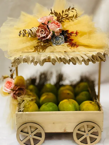Gifting can be creative, like this beautifully decorated mango hamper on wheels. It's a unique and healthy gift idea, especially during the summer season.