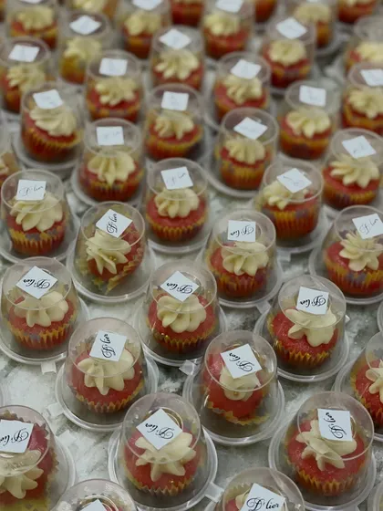Hundreds of our mini red velvet cupcakes with cream cheese frosting, individually packaged and ready to be served as wedding favors. We ensure every detail is perfect for your big day.