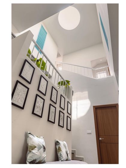 An upward-looking shot of a multi-level staircase with a skylight. This photograph captures the sense of height, light, and open space in the home's architecture.