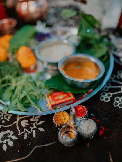 A close-up shot of the traditional items on a puja thali for an engagement ceremony. These detail shots preserve the cultural richness of your event.