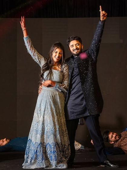 The finale pose of an energetic friends' performance, with the couple taking center stage.