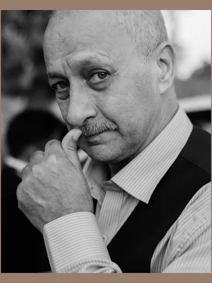 A striking black and white portrait of a male wedding guest. The close-up shot and his thoughtful expression create a compelling character study, capturing the personalities present at the event.