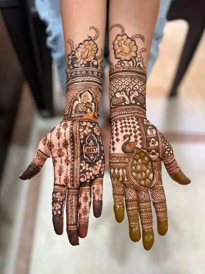 A unique design combining a large peacock on one hand with a bride figure on the other, topped with lotus flowers on the wrists.