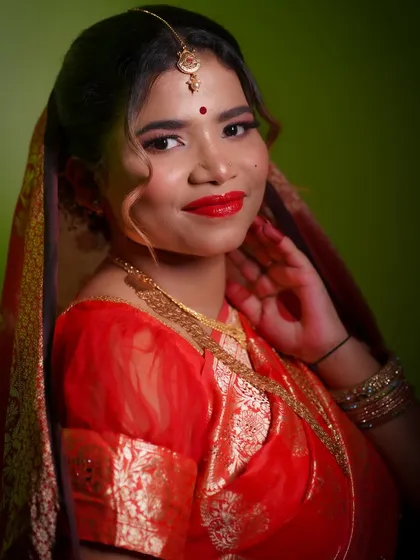 A smiling bride radiating happiness. The classic red lip and soft glam eyes create a look that is both traditional and universally beautiful.