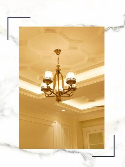 The chandelier is often the jewel of the room. This classic five-arm fixture, paired with a detailed ceiling medallion and cove lighting, creates a warm and luxurious focal point in the drawing room.