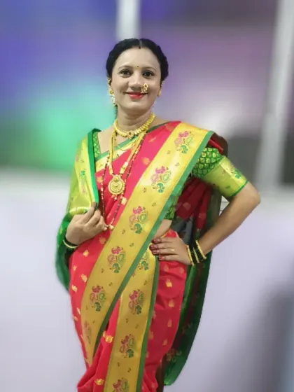 A client dressed in a traditional red and green Paithani saree. This classic Maharashtrian look is perfect for festivals and family functions, and I ensured the drape highlighted the rich peacock border.