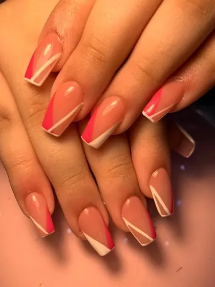 A modern geometric French manicure with angled pink and white tips on square nails.