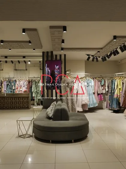 This wide shot of the Jubinav Chadha Fashion Design Studio in New Delhi captures the overall retail environment I created. The design, inspired by Indian temple carvings, features a central seating area, custom display racks, and strategic track lighting to create an immersive and high-end shopping experience.