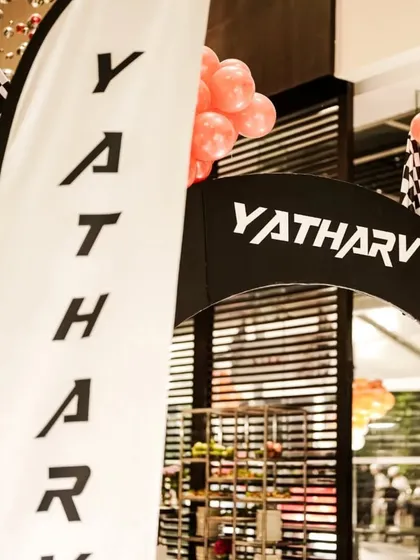 A personalized race-themed entrance arch welcomes guests to the party. The custom branding and checkered flag details create an immersive experience from the moment guests arrive.