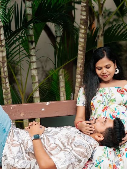 A peaceful and romantic moment for this expecting couple. The relaxed pose, with his head on her lap, creates a feeling of comfort, trust, and intimacy.