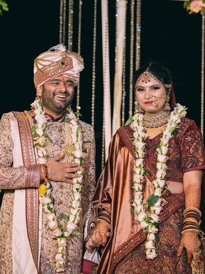 The newly married couple standing together, hand in hand. A classic portrait capturing their happiness and the beginning of their new life.