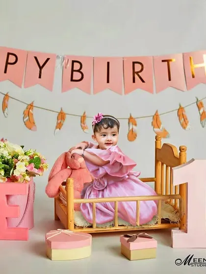 A first birthday is a huge milestone, and I love creating vibrant, celebratory scenes like this one. This setup features a 'Happy Birthday' banner, floral arrangements, and custom 'ONE' blocks, all themed in pink for this little girl's special day.