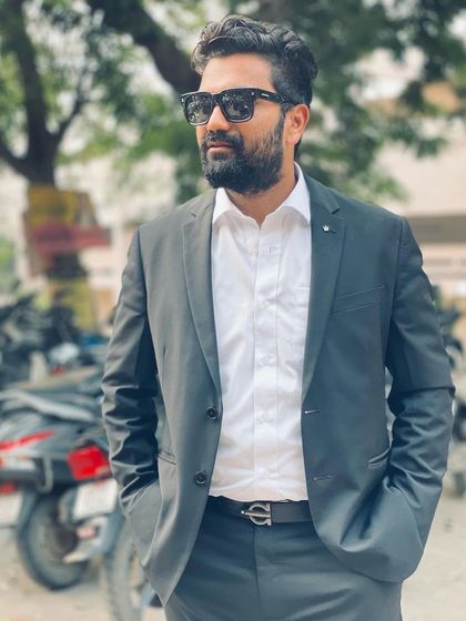 Dressed for court, standing outside near a parking area. In the legal profession, as in life, one needs an attitude of survival and the determination to see things through.