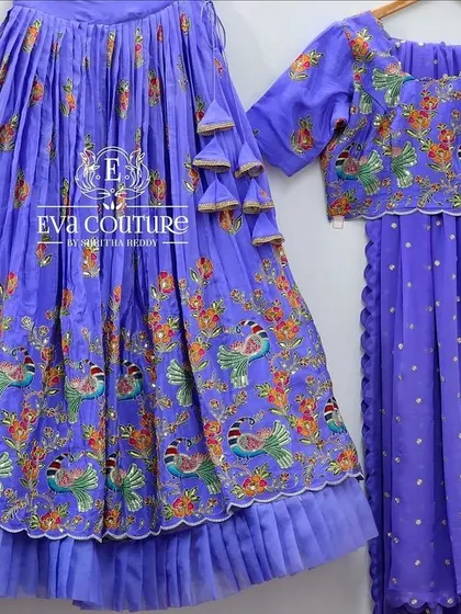A similar peacock-print lehenga in a beautiful royal blue color, shown with a matching blouse and dupatta.