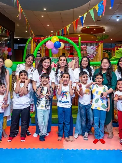 A wonderful group photo of all the kids and moms at our Holi celebration.