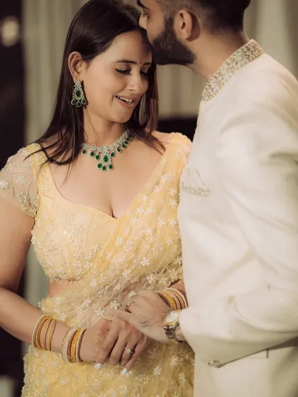 A close-up portrait focusing on the quiet intimacy between the couple. This shot highlights their elegant traditional attire and the gentle connection they share, perfect for an engagement album.