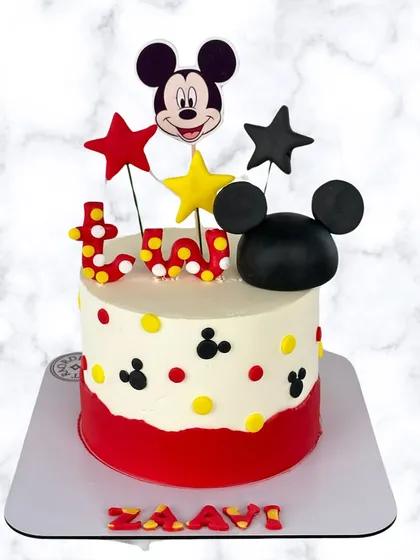 Oh boy! A classic Mickey Mouse cake for a magical second birthday. The design uses Mickey's iconic colors with fun polka dots, stars, and signature ears.