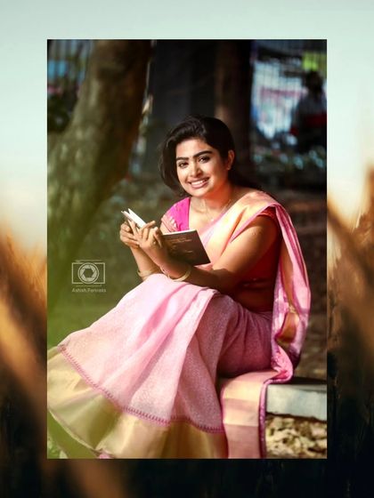 Another reading pose, this time with a smile. The makeup is consistent and looks great from different angles and with different expressions.