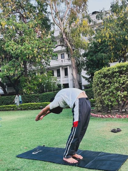 Practicing asanas is a part of yoga, but not the whole of it. Here, an instructor demonstrates a deep backbend outdoors.
