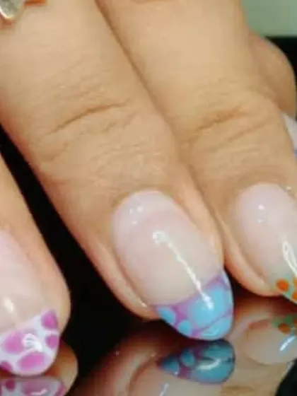 A close-up view of the colorful spotted French tips, highlighting the playful and unique design.