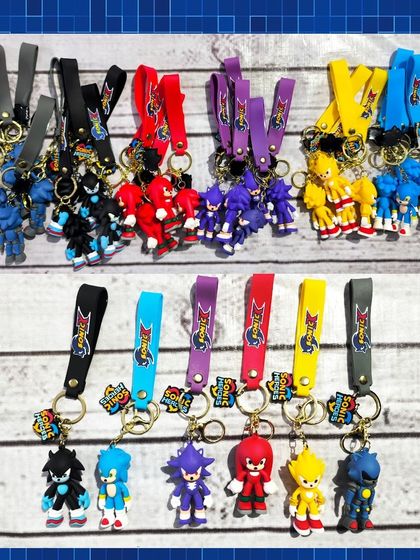 A collection of colorful Sonic the Hedgehog character keychains, including Sonic, Shadow, Knuckles, and Super Sonic.