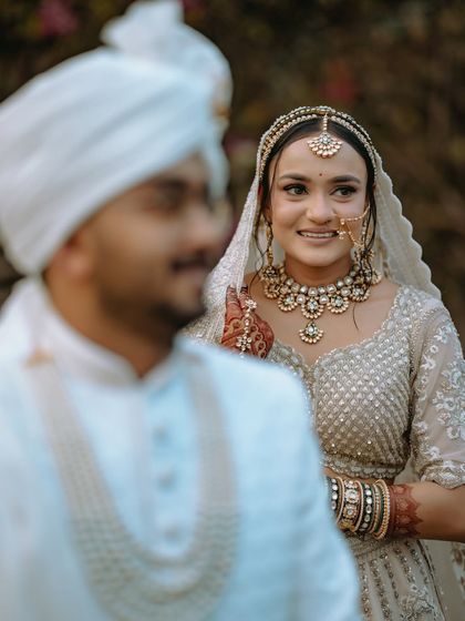 The bride's beautiful smile as she looks towards her groom, captured in a soft, natural light.