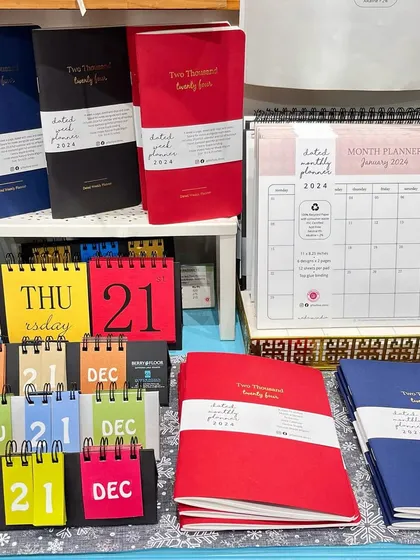 A display of our 2024 planners and calendars in our store. From weekly and monthly planners to our colorful perpetual calendars, we have something to help everyone get organized.