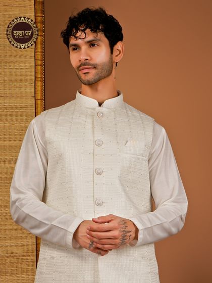 Effortless elegance in every thread. An off-white textured Nehru jacket paired with a matching kurta, a classic and versatile choice.