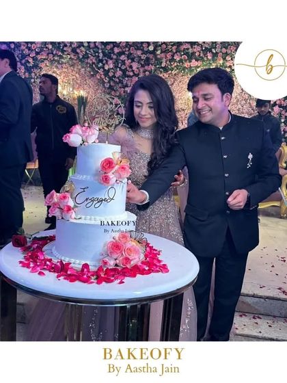 Here is the happy couple cutting their three-tier engagement cake. Being trusted with such an important part of their celebration is an honor.