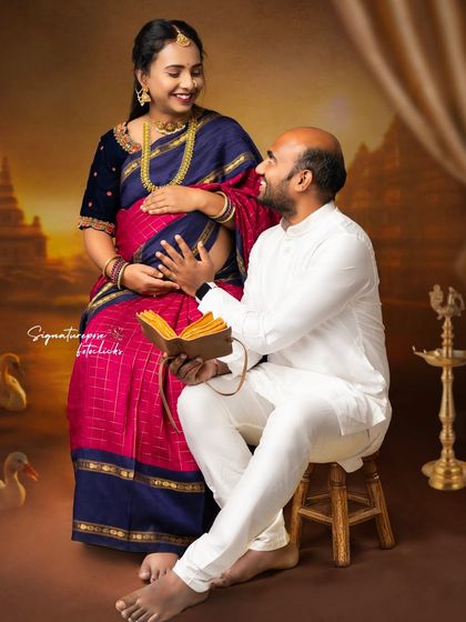 The joy in their interaction is the focus here, set against a backdrop that evokes South Indian temple architecture.