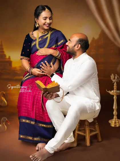 The joy in their interaction is the focus here, set against a backdrop that evokes South Indian temple architecture.
