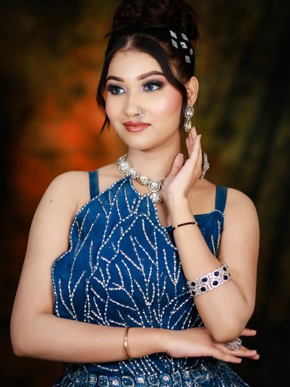 A full shot of the model in a stylish blue dress, ready for a night out.