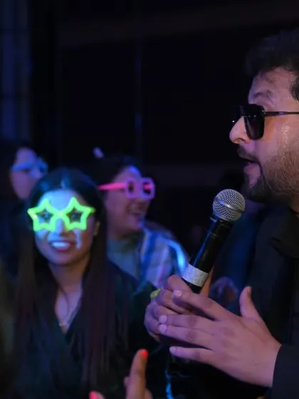 A singer interacting with the audience during a live show. These candid moments of connection between the performer and the crowd are essential to telling the event's story.