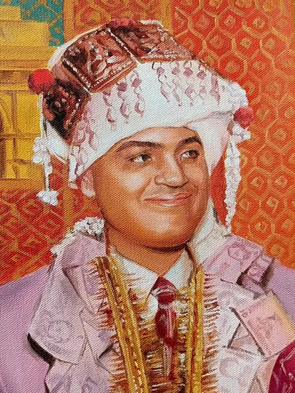 A close-up of the groom from the same portrait, with the India Gate representing Delhi in the background.