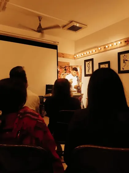 A view from the audience, completely absorbed in a performance at 'Tuesdays with the Bard'. The intimate setting allows for a deep connection between the poet on stage and the listeners.