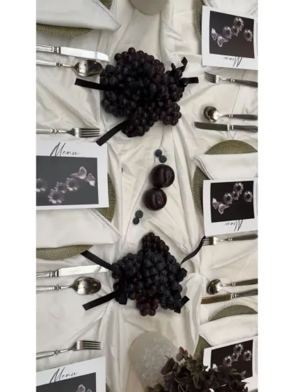 An overhead shot of the full tablescape, showing the thoughtful placement of each element, from the grapes to the custom menus.
