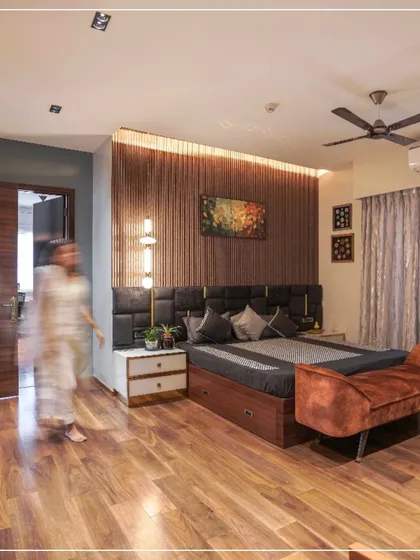 Another view of the bedroom from image 8, with a person walking through, giving a sense of scale and life.